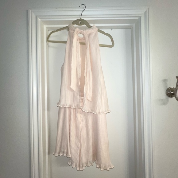 Adorable cream chiffon ruffle short romper with tie back. Open winged back. - Picture 3 of 13